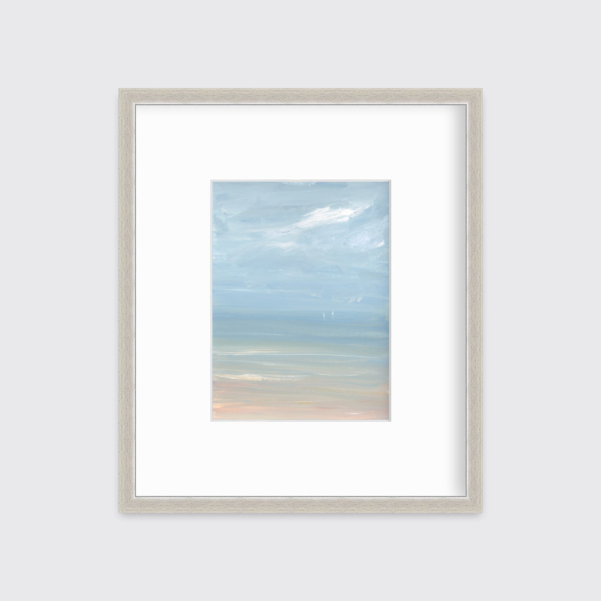 A white, blue and beige abstract seascape print in a silver frame with a mat hangs on a white wall.