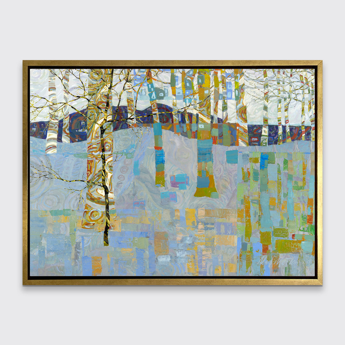 A multicolored abstract landscape in a gold floater frame hangs on a white wall.