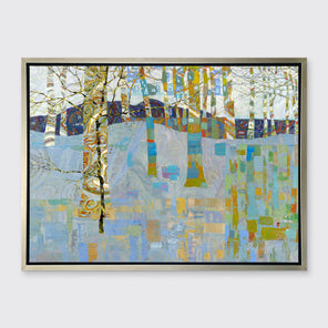 A multicolored abstract landscape in a silver floater frame hangs on a white wall.