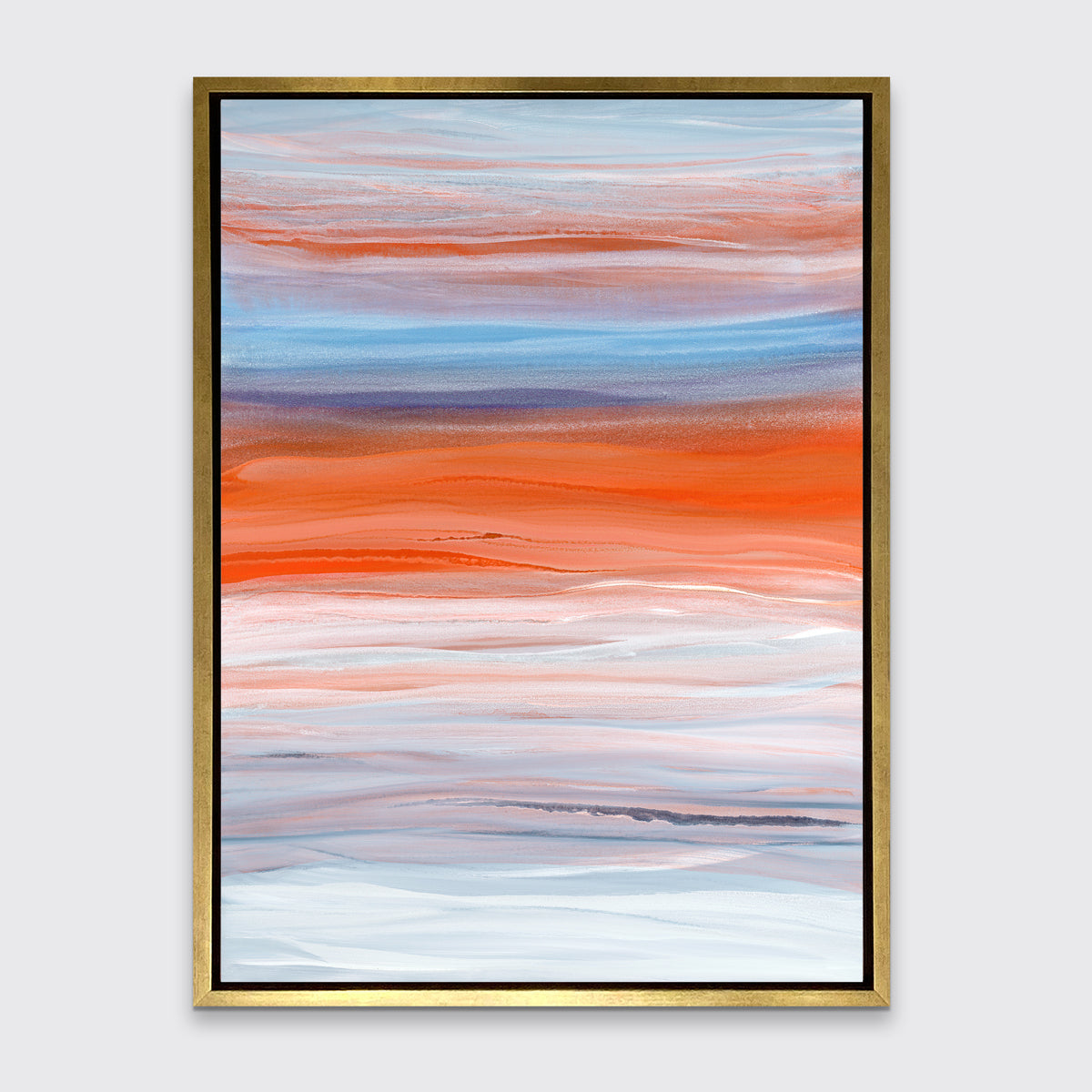 A blue, orange, light pink and white abstract print in a gold floater frame hangs on a white wall.