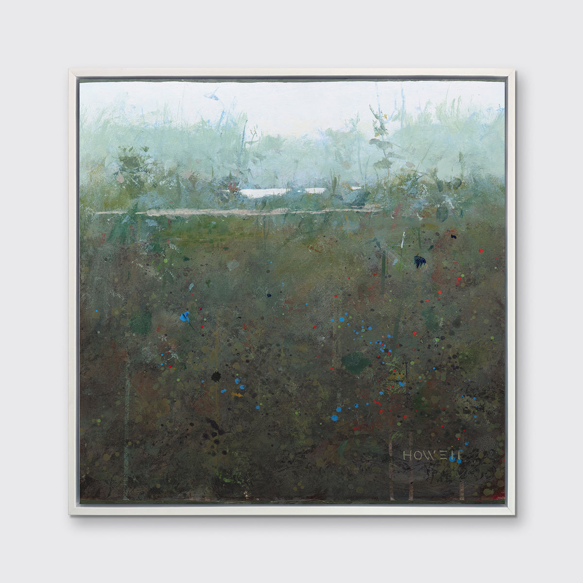 A dark green and grey abstract landscape print in a white floater frame hangs on a white wall.
