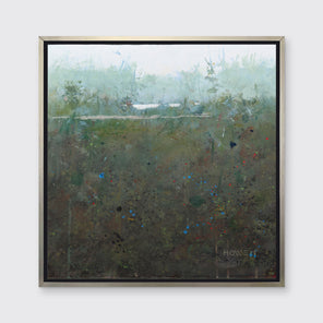 A dark green and grey abstract landscape print in a silver floater frame hangs on a white wall.