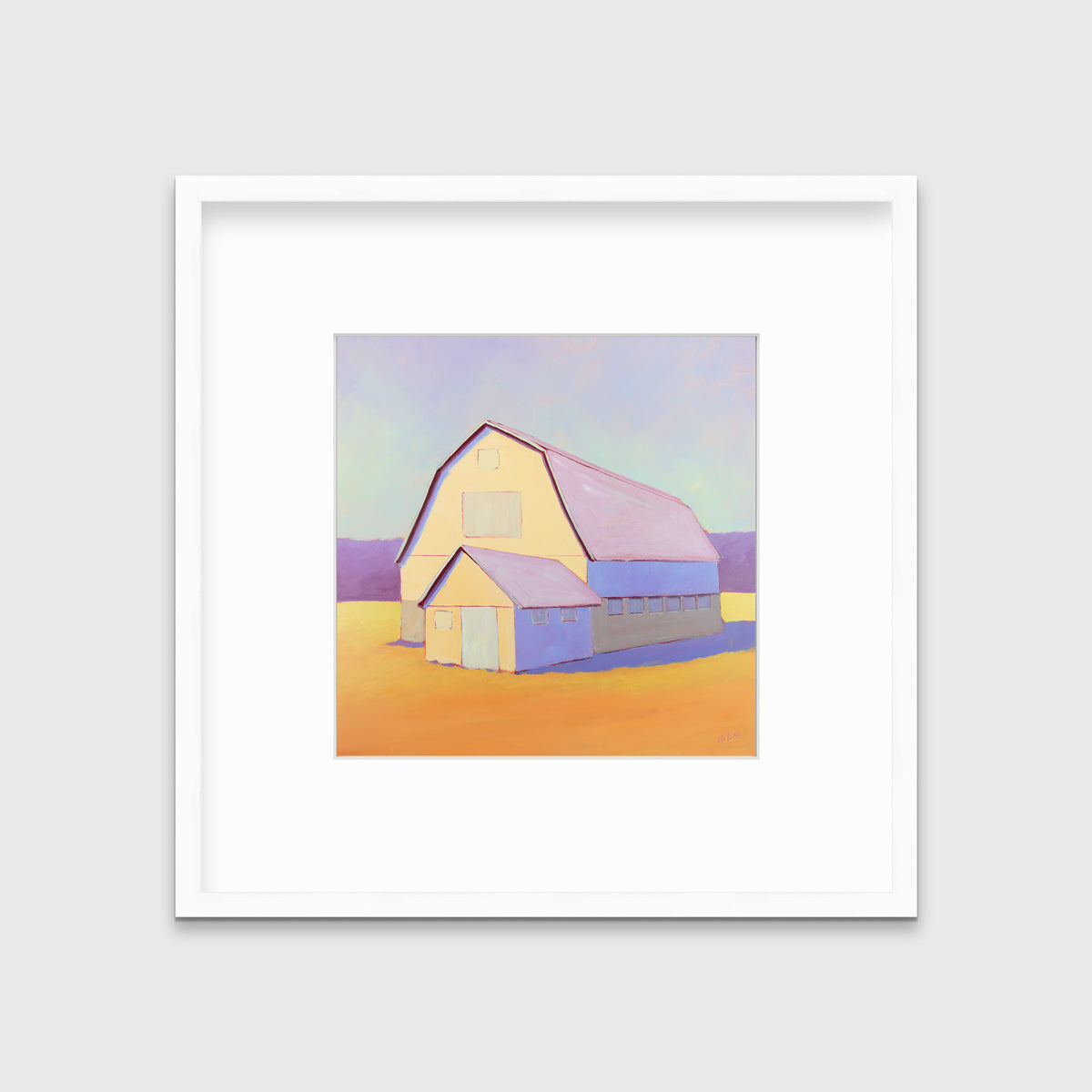 A lavender, light yellow and orange landscape print of a barn in a white frame with a mat hangs on a white wall.