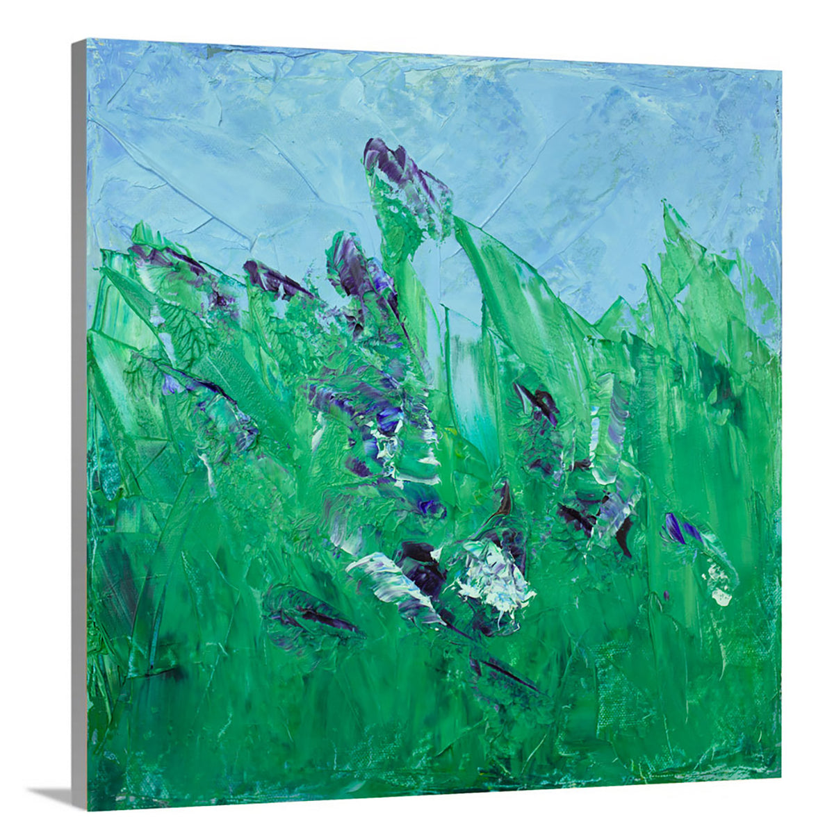 A side-angle view of a blue and green abstract landscape print on canvas.