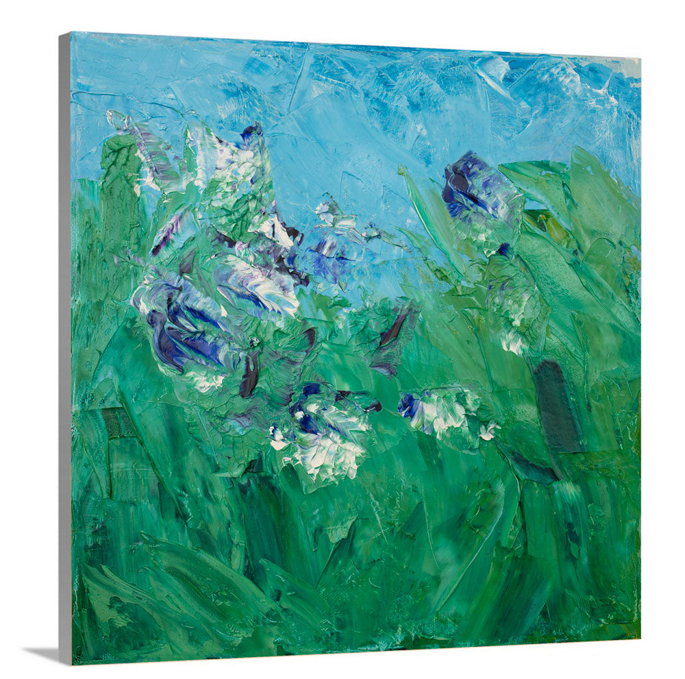 A side-angle view of a blue, green, purple and white abstract landscape print on canvas.