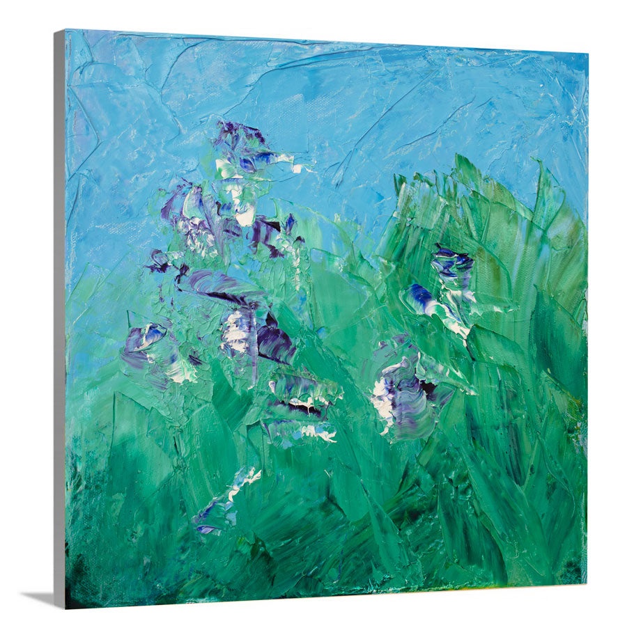 A side-angle view of a blue, green, purple and white abstract landscape print on canvas.