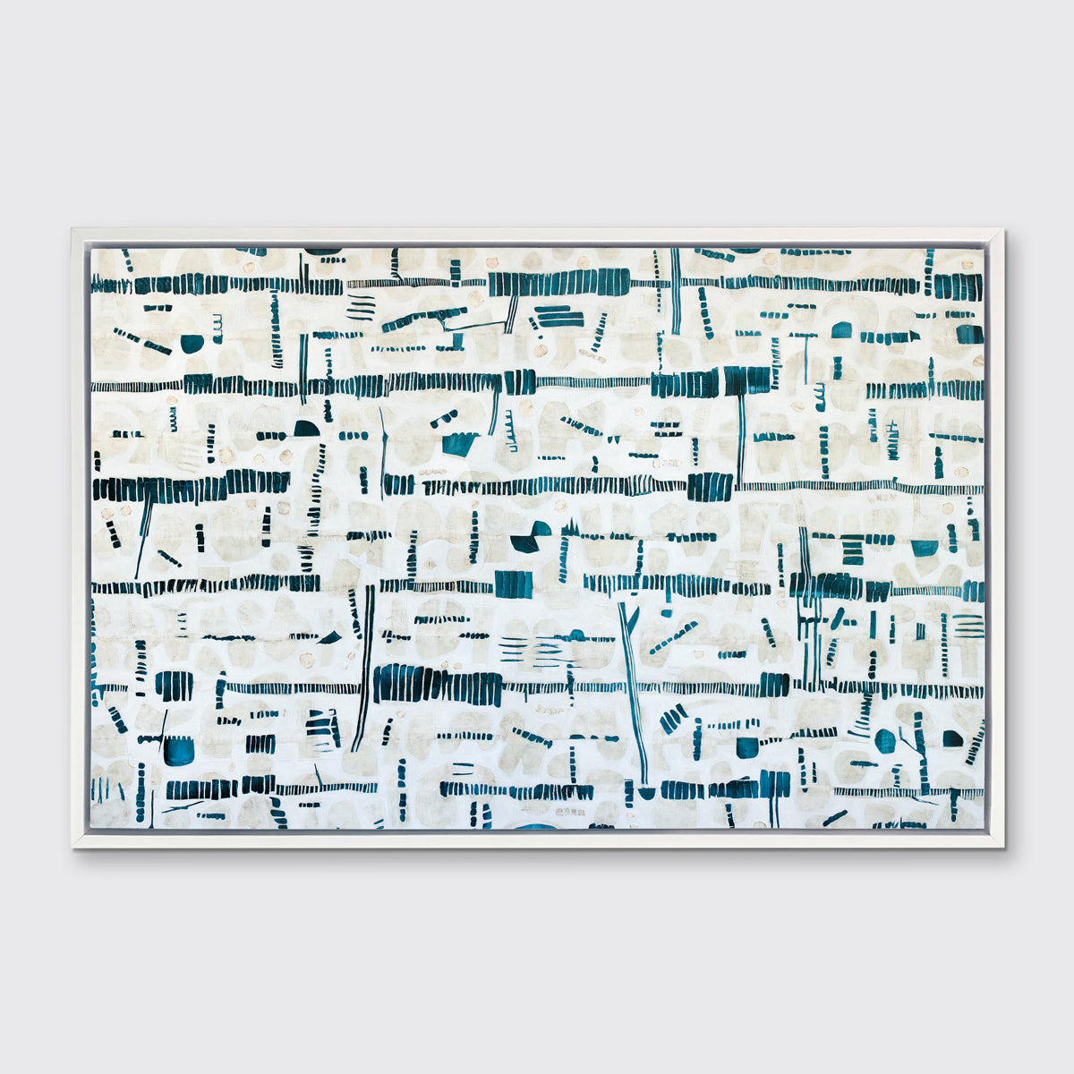 A dark teal, white and beige abstract print in a white floater frame hangs on a white wall.