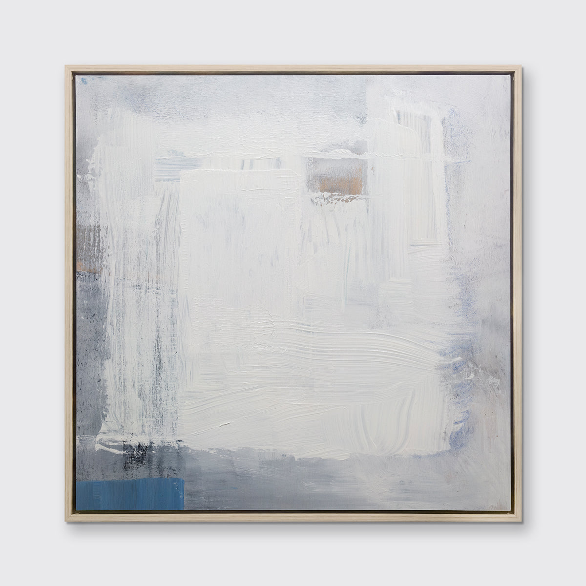 A white, grey and blue abstract print in a white oak wood floater frame hangs on a white wall.