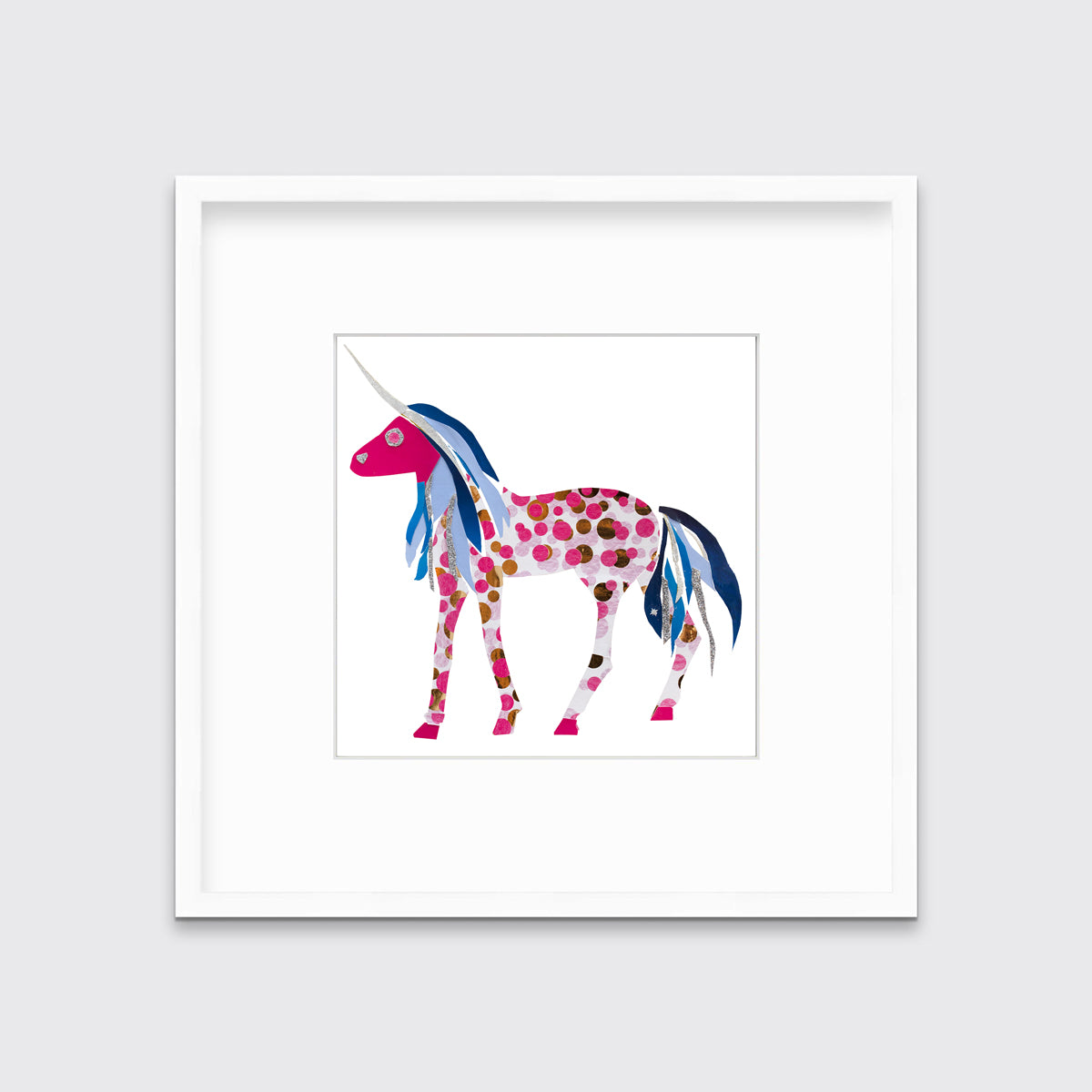 A white, pink, blue and silver collaged unicorn print in a white frame with a mat hangs on a white wall.