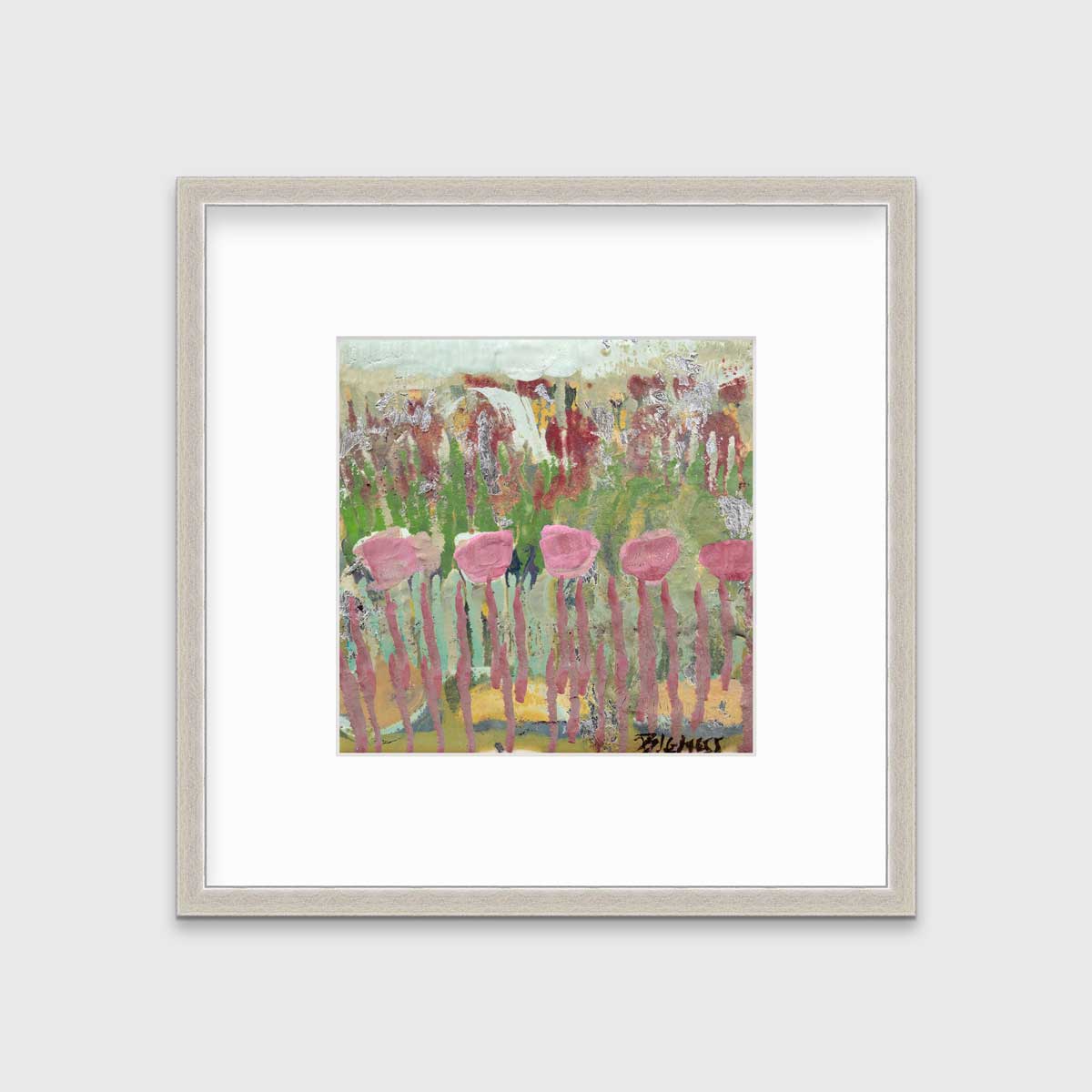 A green, pink and teal abstract floral print in a silver frame with a mat hangs on a white wall.