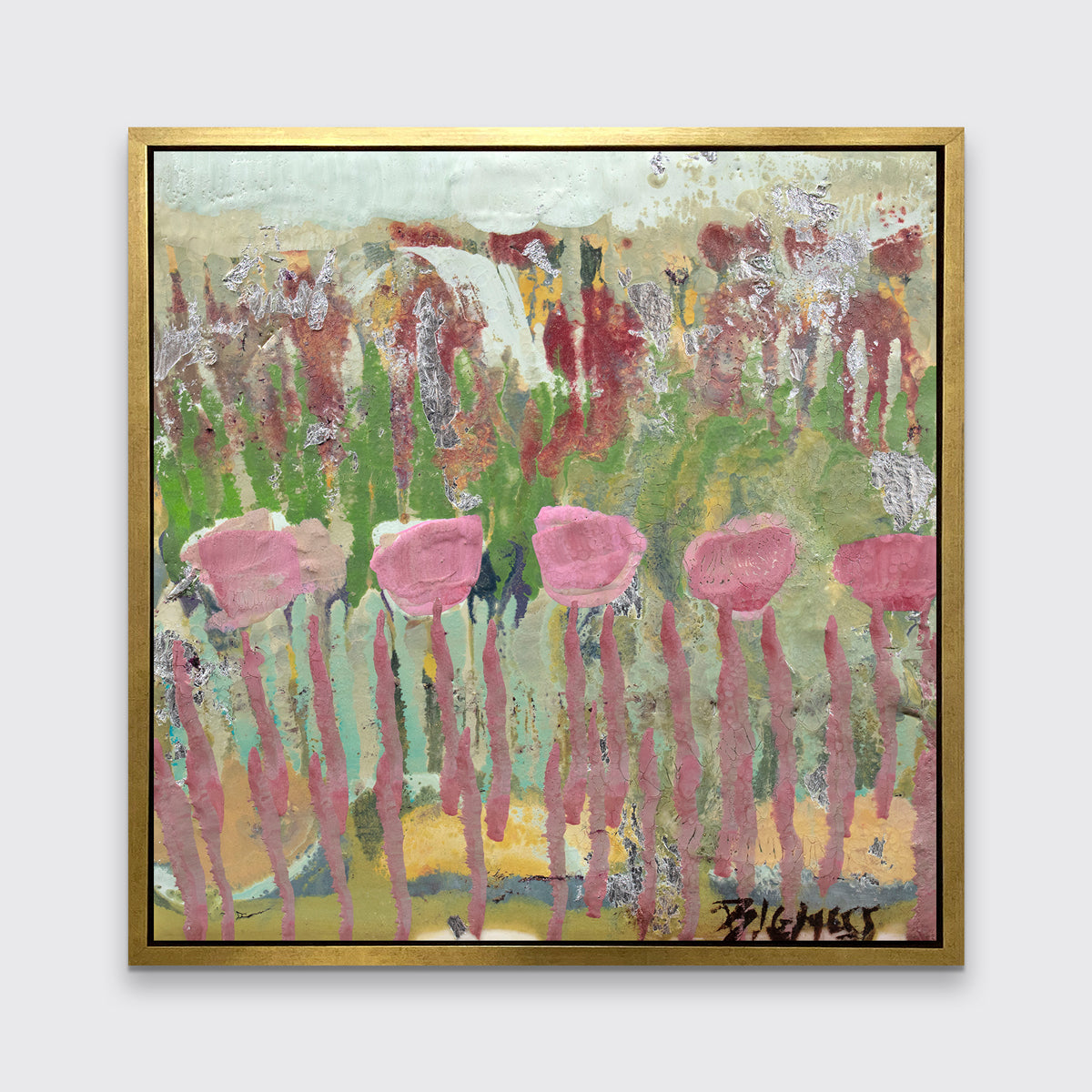 A green, pink and teal abstract floral print in a gold floater frame hangs on a white wall.