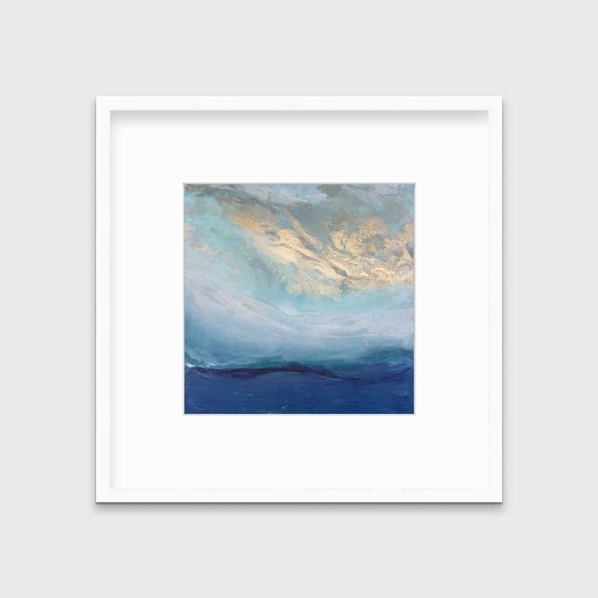 A blue, gold and teal abstract print in a white frame with a mat hangs on a white wall.