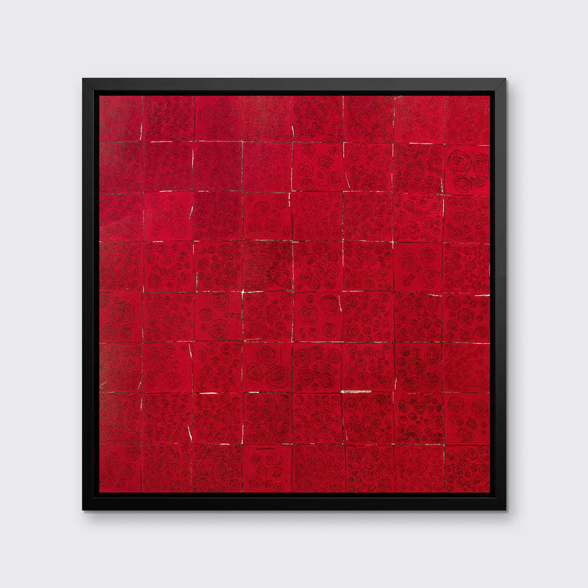 A red and black abstract geometric print in a black floater frame hangs on a white wall.