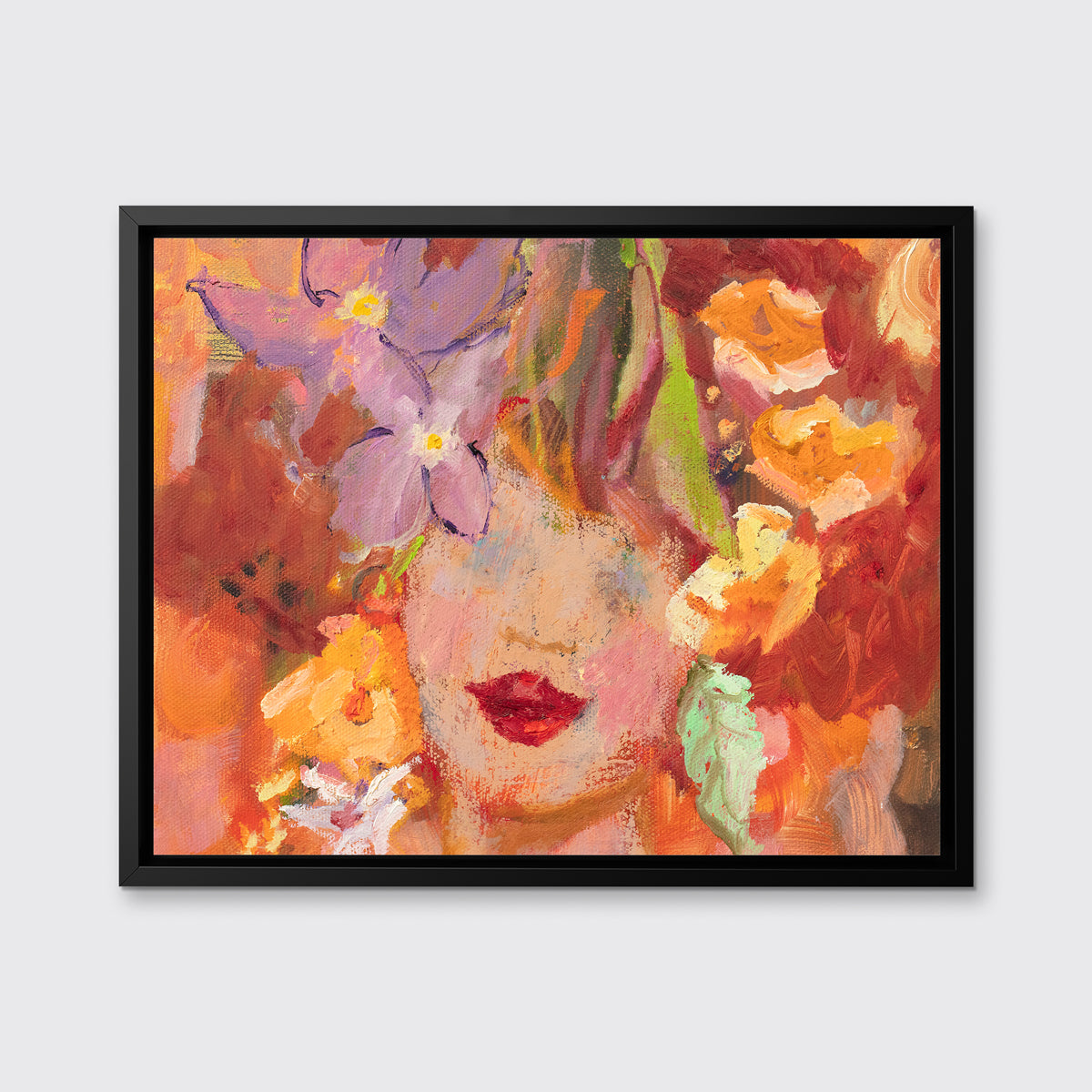 A red, orange, yellow and purple figural print in a black floater frame hangs on a white wall.