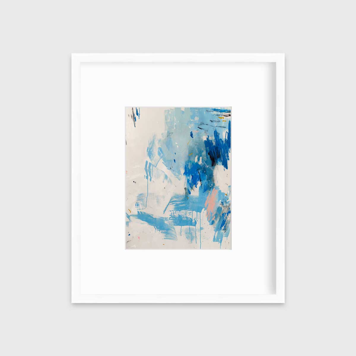 A blue, peach and white abstract print in a white frame with a mat hangs on a white wall.