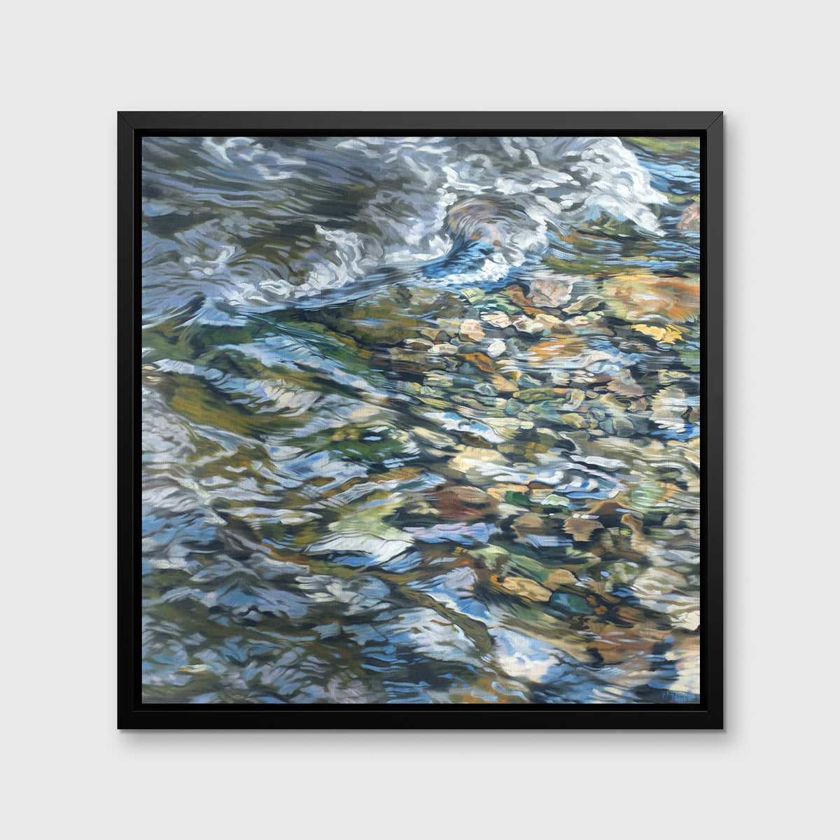 An abstracted riverbed print in a black floater frame hangs on a white wall.