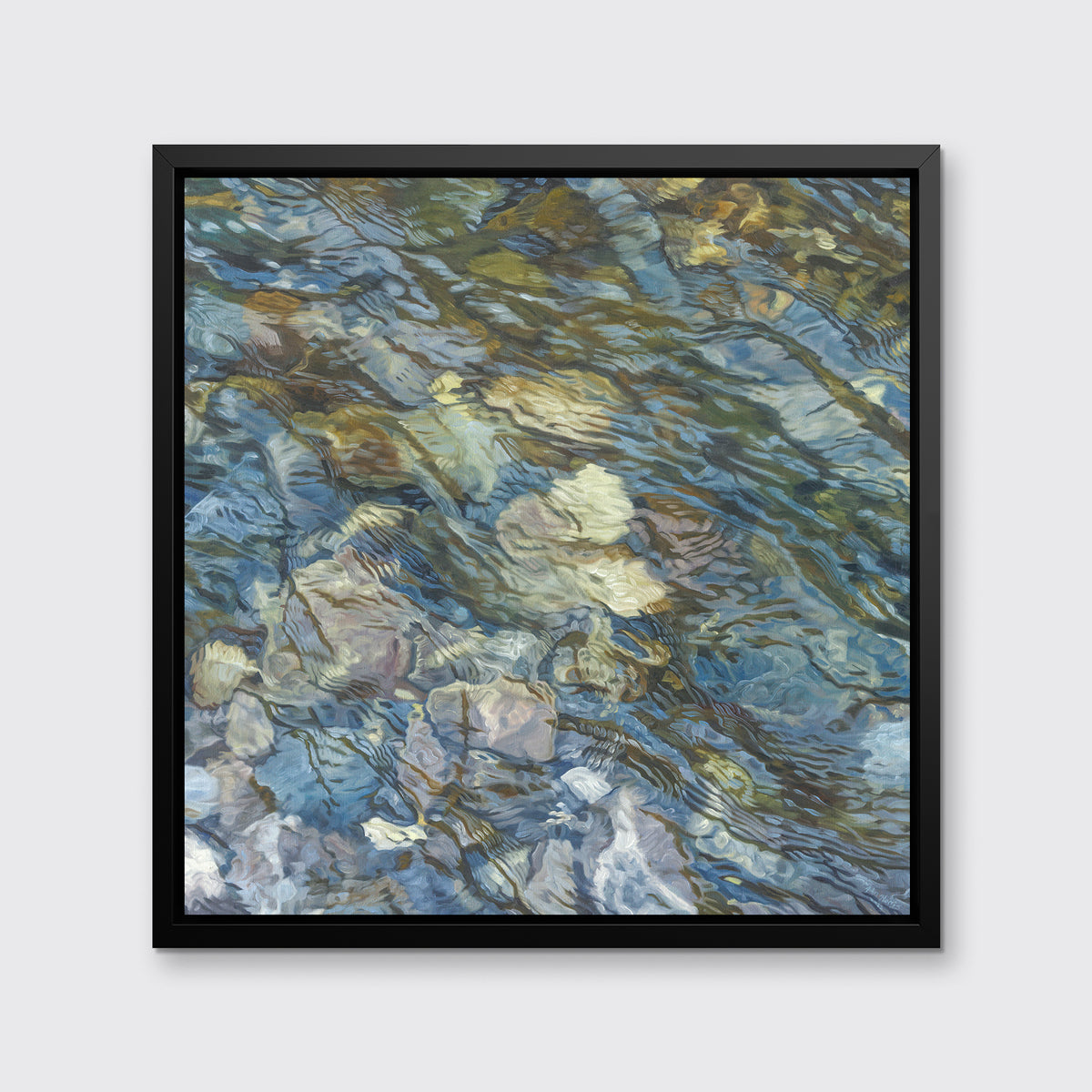 An abstract river bed print in a black floater frame hangs on a white wall.