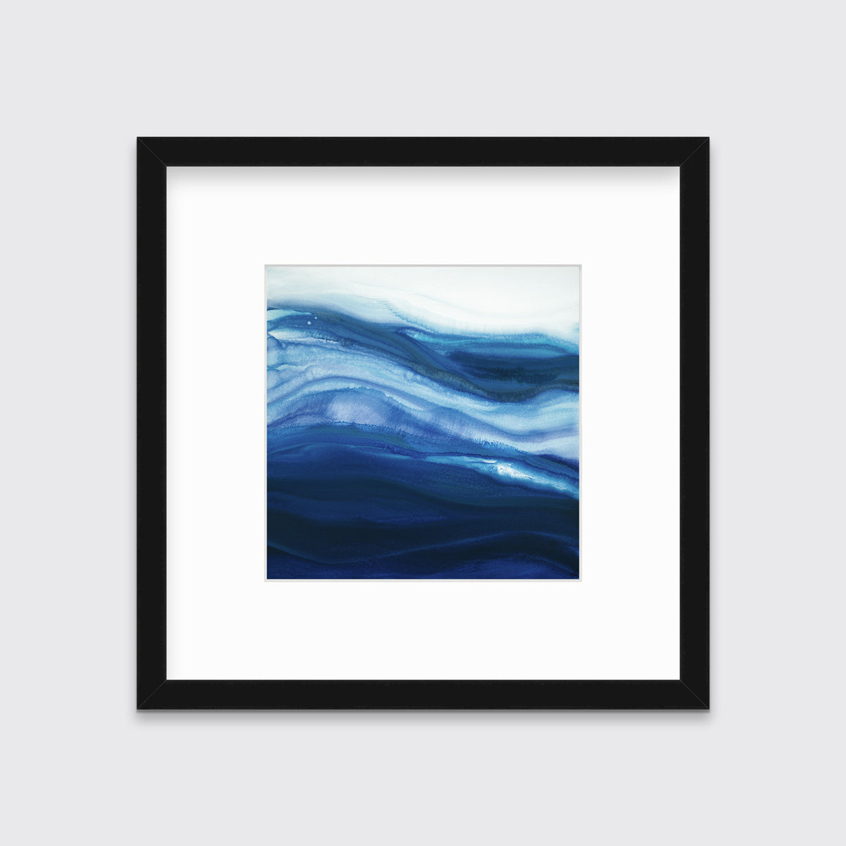 A blue, teal and white abstract print in a black frame with a mat hangs on a white wall.