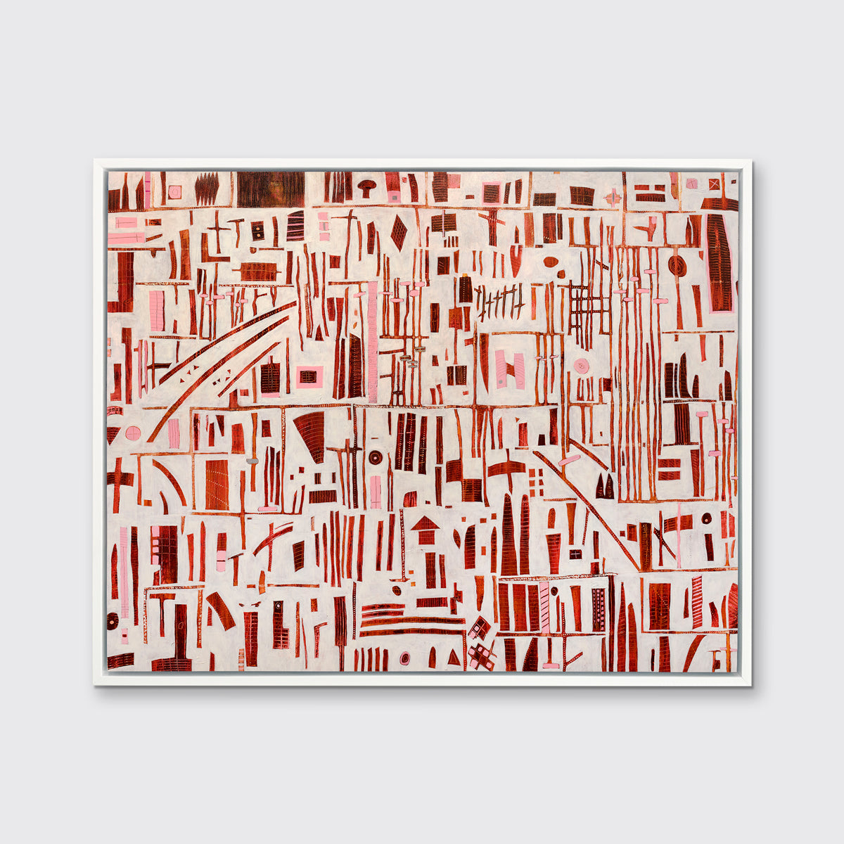 A red, pink and white abstract print in a white floater frame hangs on a white wall.