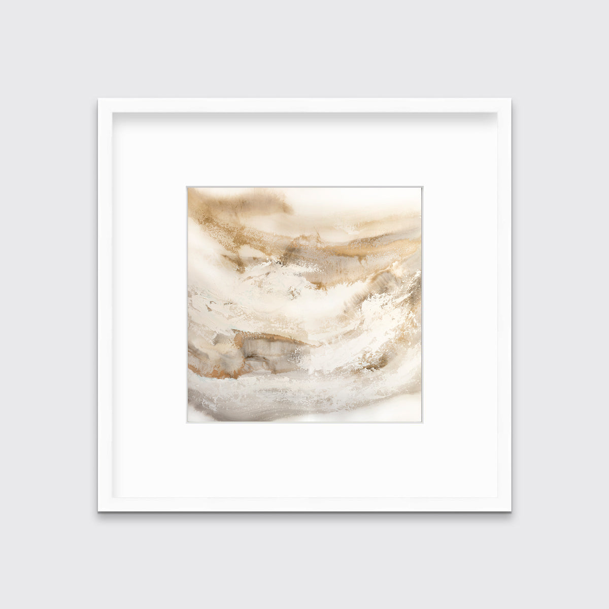 A gold, silver, white and beige abstract print in a white frame with a mat hangs on a white wall.