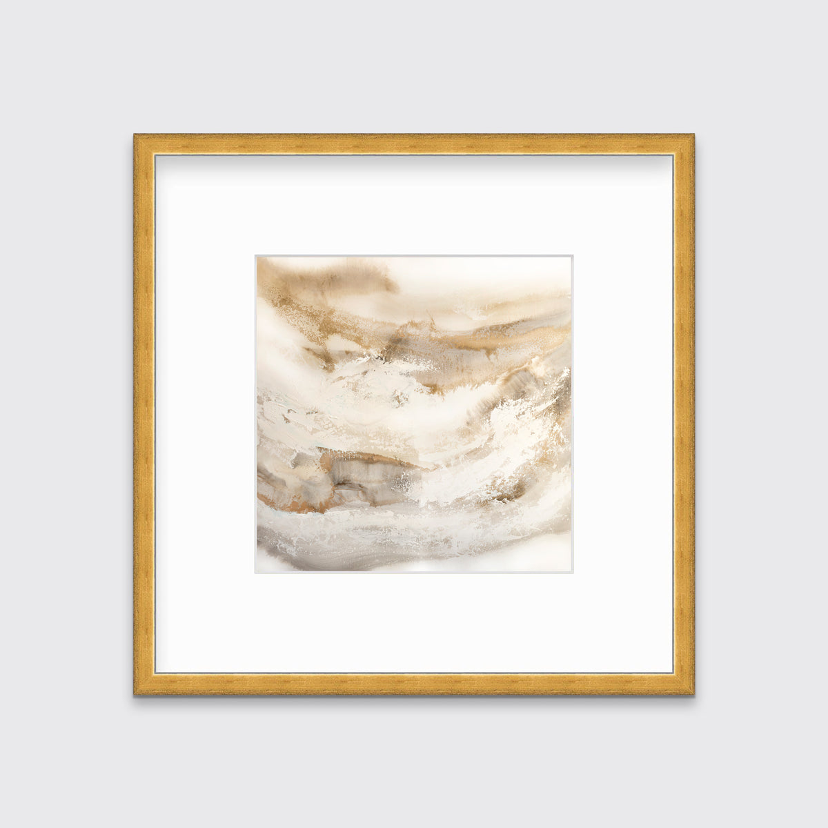 A gold, silver, white and beige abstract print in a gold frame with a mat hangs on a white wall.