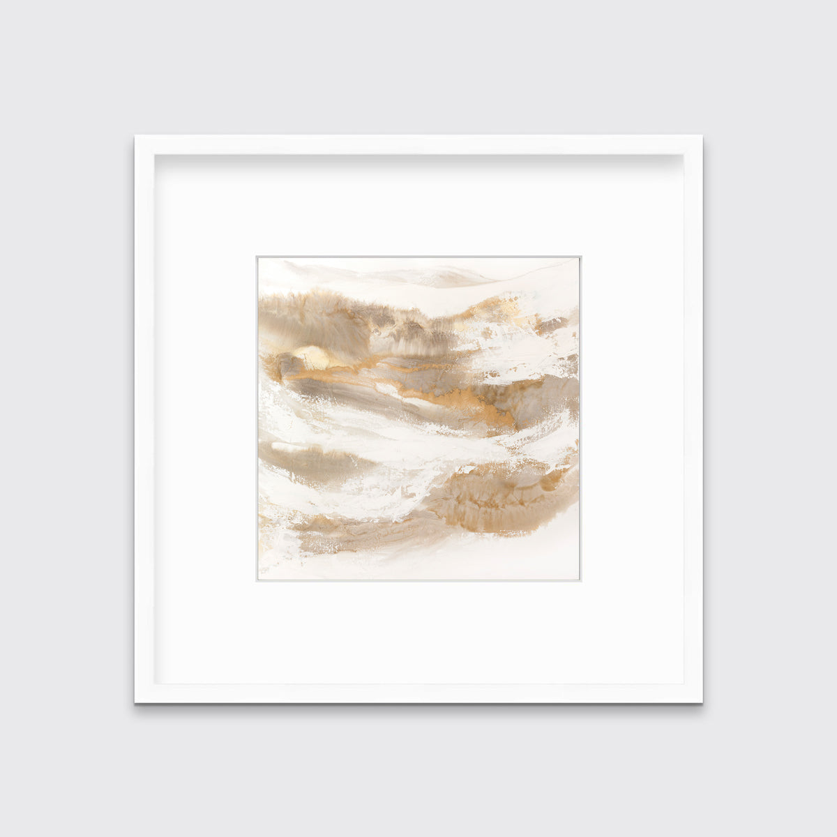 A gold, silver, white and beige abstract print in a white frame with a mat hangs on a white wall.