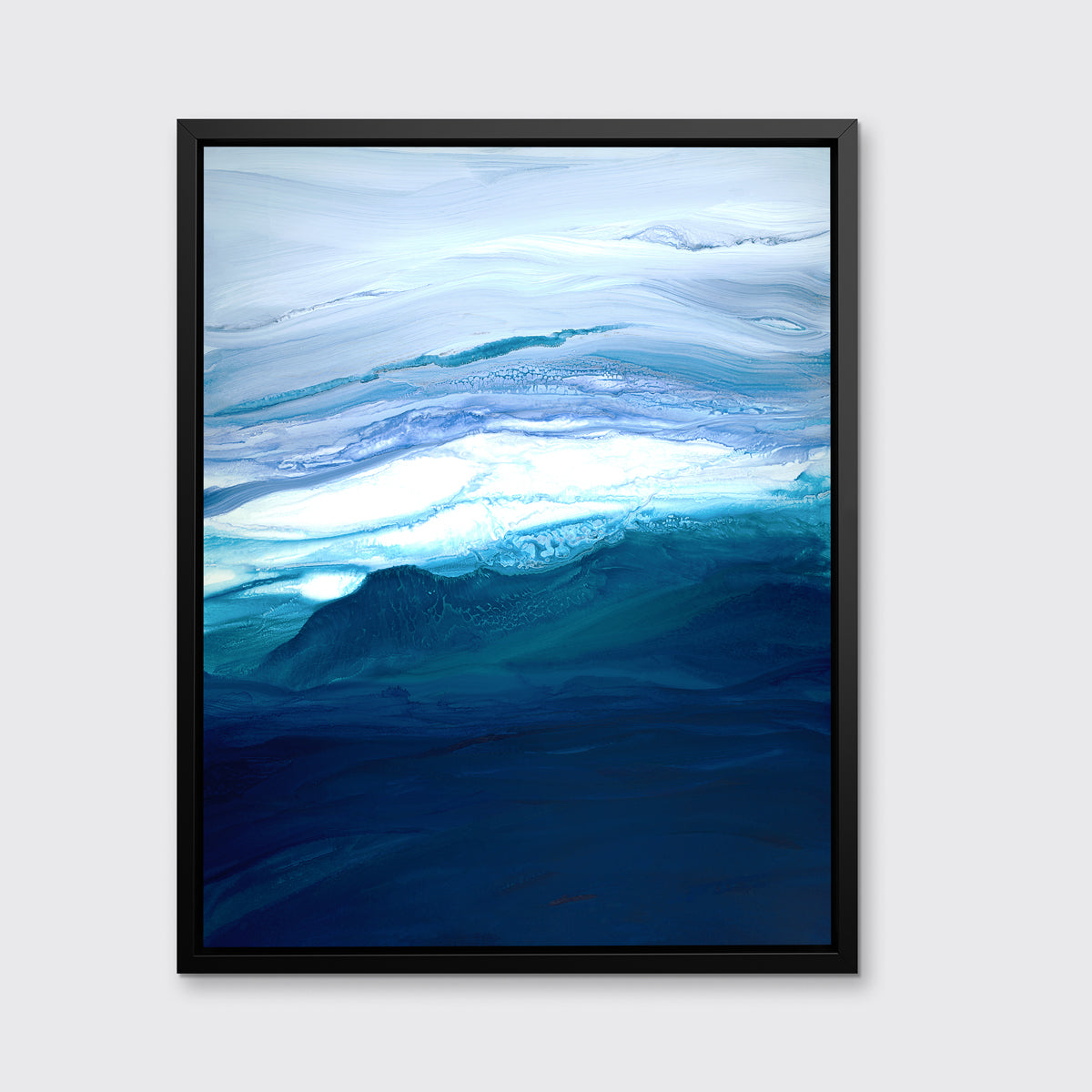 A blue, teal, lavender and white abstract print in a black floater frame hangs on a white wall.