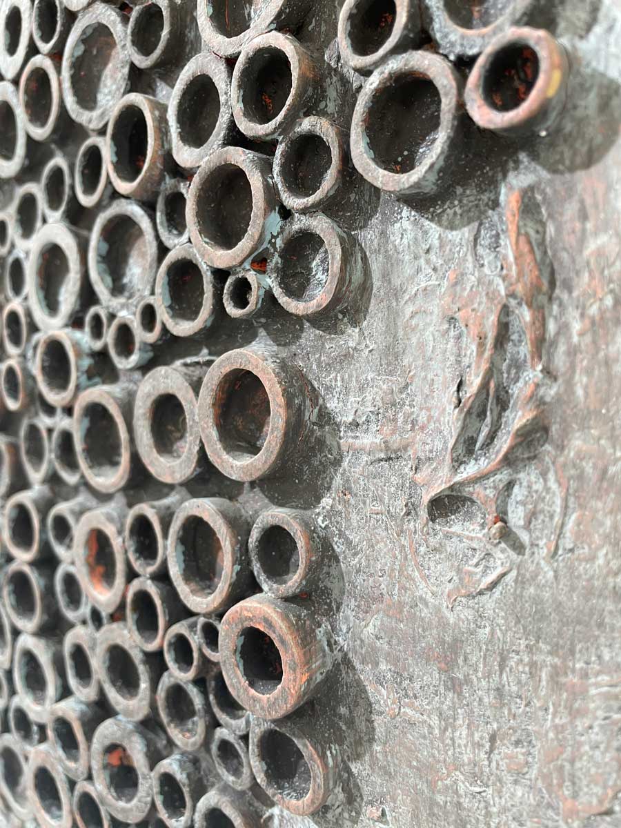 A close up of the wood circle attached to the painting.