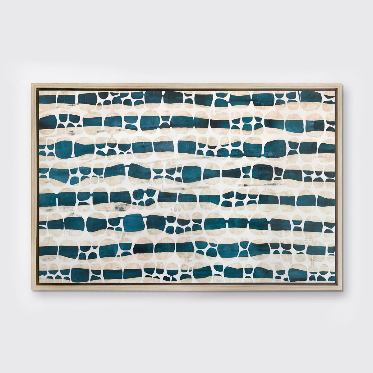 A white, dark teal and beige abstract print in a white oak wood floater frame hangs on a white wall.
