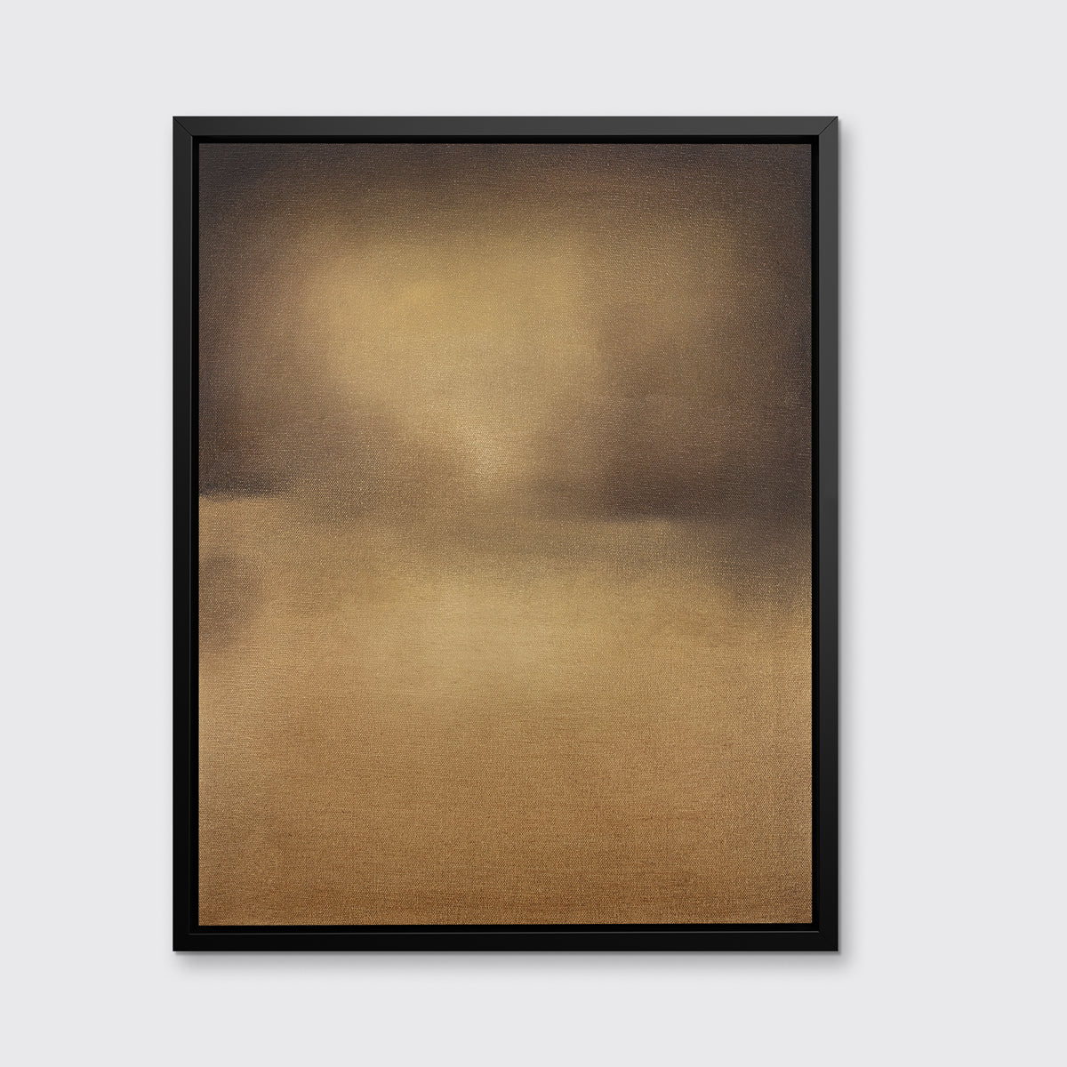 A brown and gold abstract print in a black floater frame hangs on a white wall.