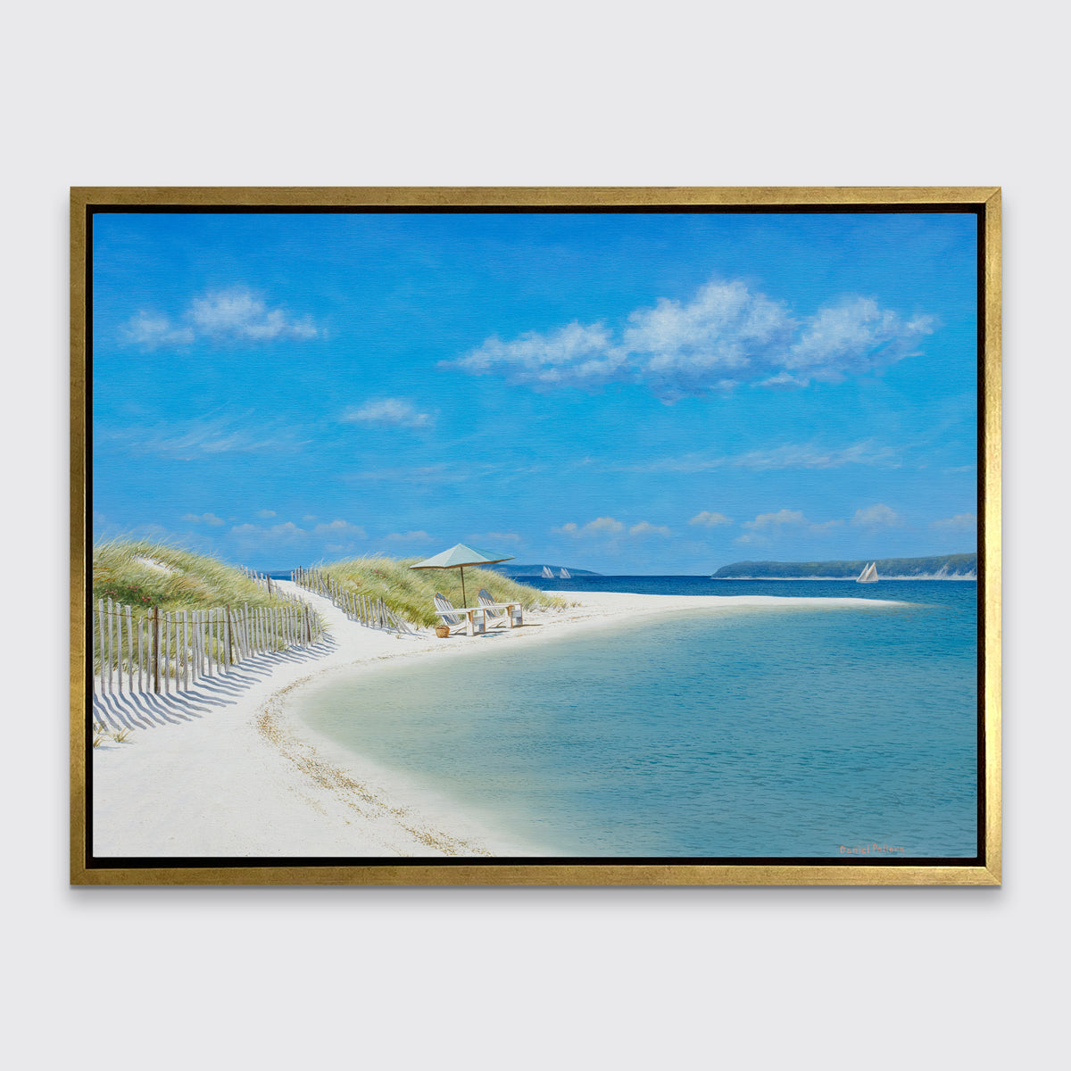 A blue, beige and light green contemporary seascape print in a gold floater frame hangs on a white wall.