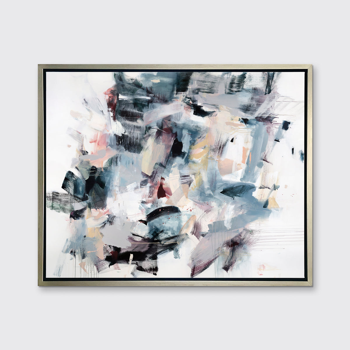 A multicolored abstract print in a silver floater frame hangs on a white wall.