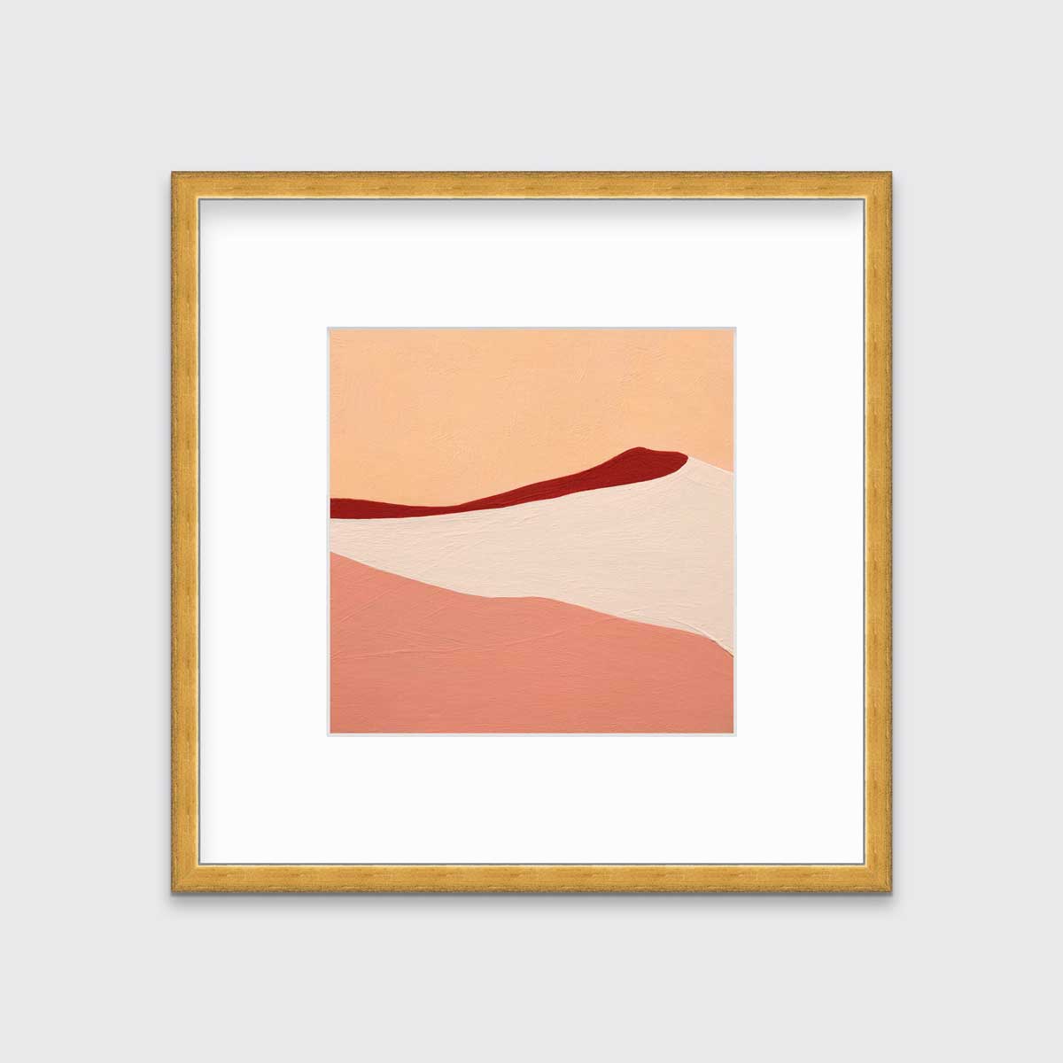 A red, peach and beige abstract print in a gold frame with a mat hangs on a white wall.
