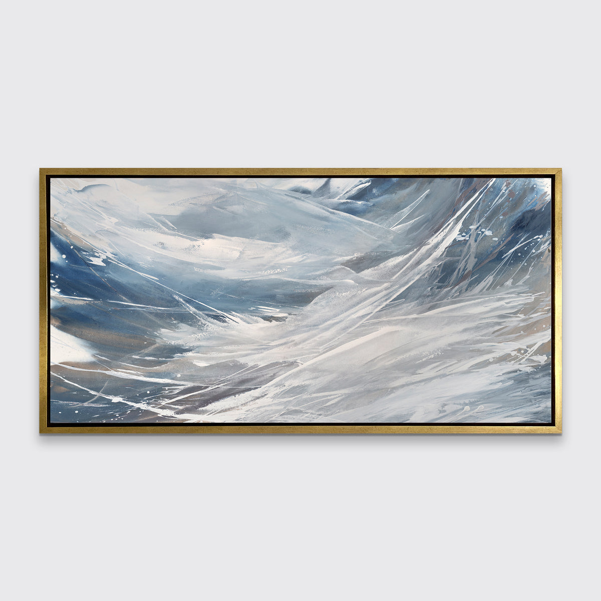 A grey, white and blue abstract print in a gold floater frame hangs on a white wall.