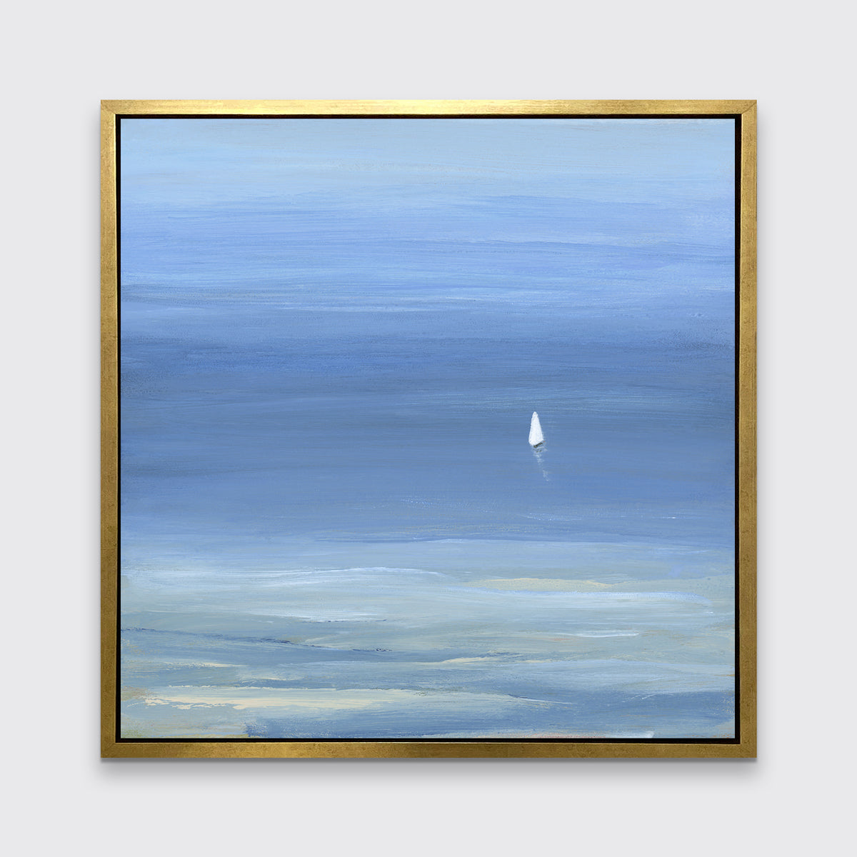 A blue, light green and white abstract seascape print with a small sailboat in a gold floater frame hangs on a white wall.