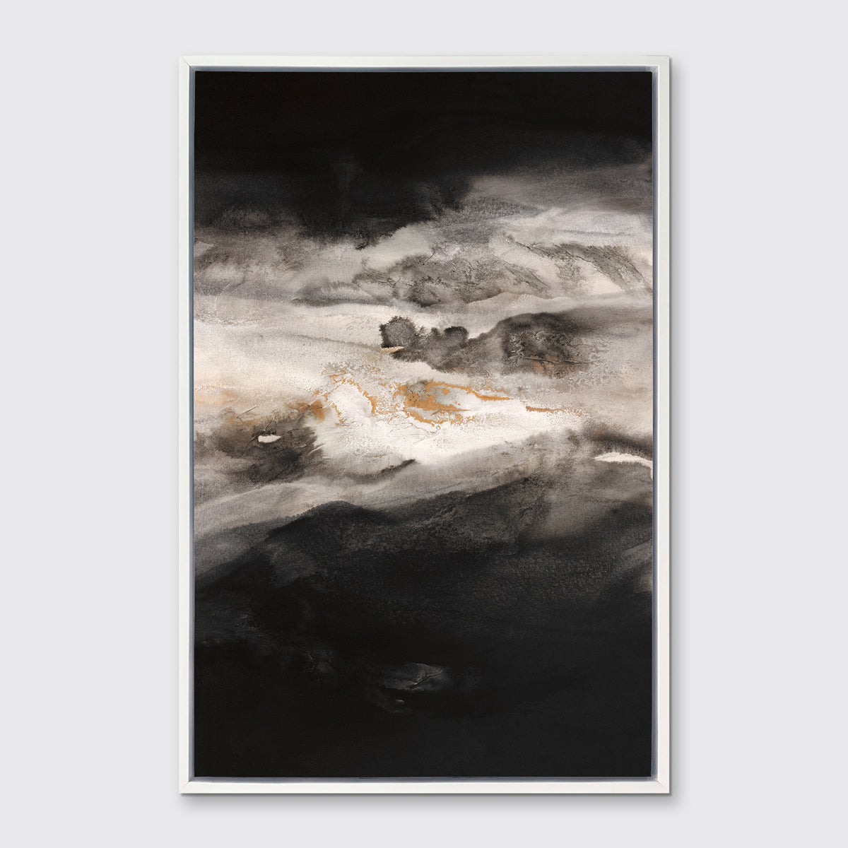 A black, white, beige and gold abstract print in a white floater frame hangs on a white wall.
