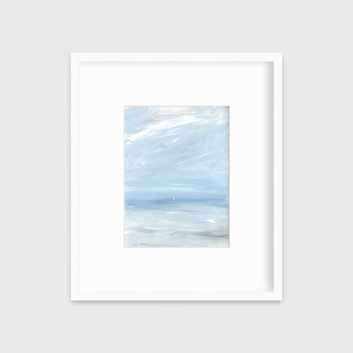 A white, blue and grey abstract seascape print in a white frame with a mat hangs on a white wall.