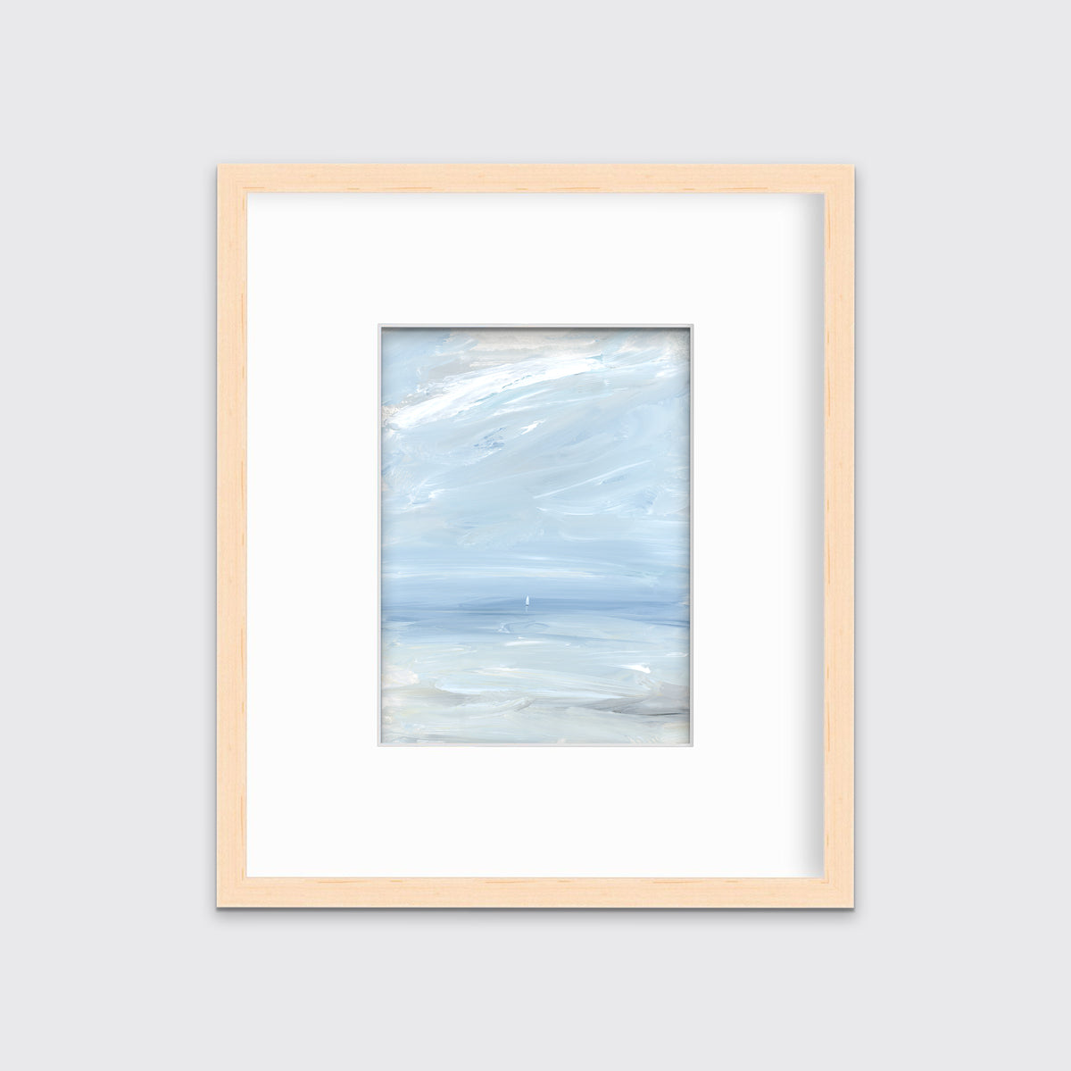 A white, blue and grey abstract seascape print in a natural wood frame with a mat hangs on a white wall.