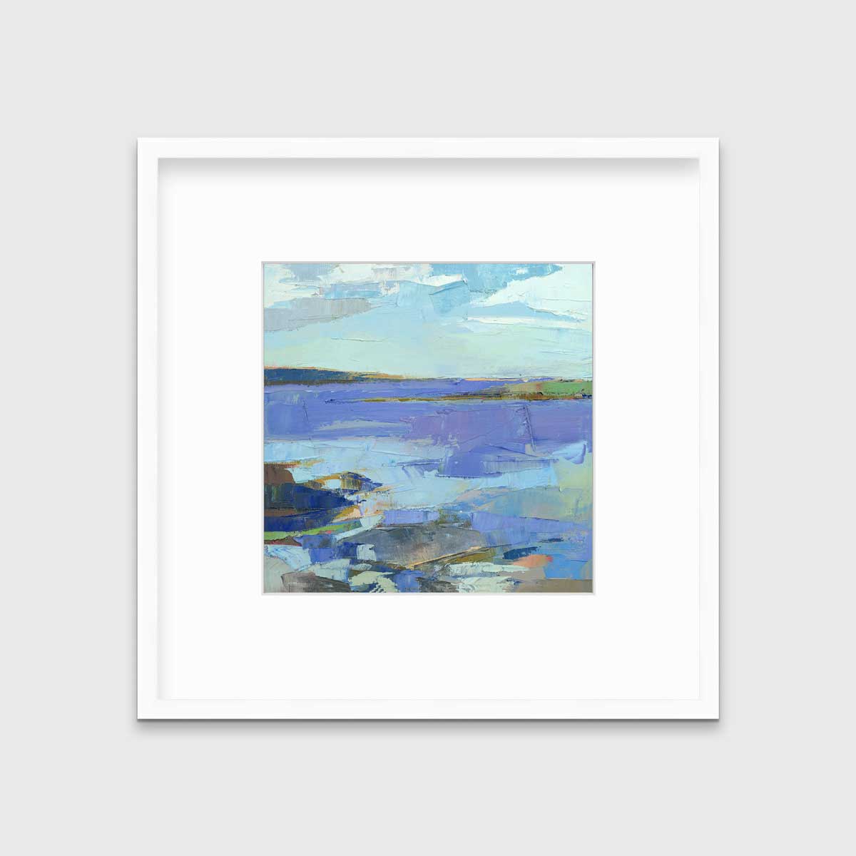 A blue, purple, white and green abstract landscape print in a white frame with a mat hangs on a white wall.