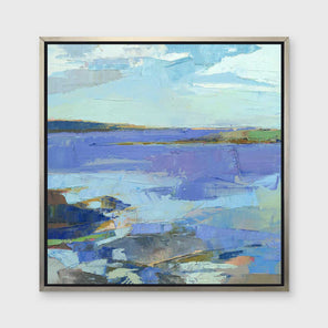 A blue, purple, white and green abstract landscape print in a silver floater frame hangs on a white wall.