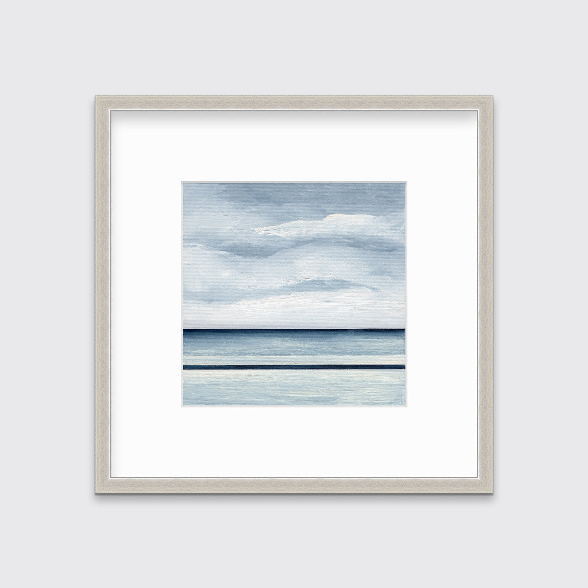 A blue and white abstract linear landscape print in a silver frame with a mat hangs on a white wall.