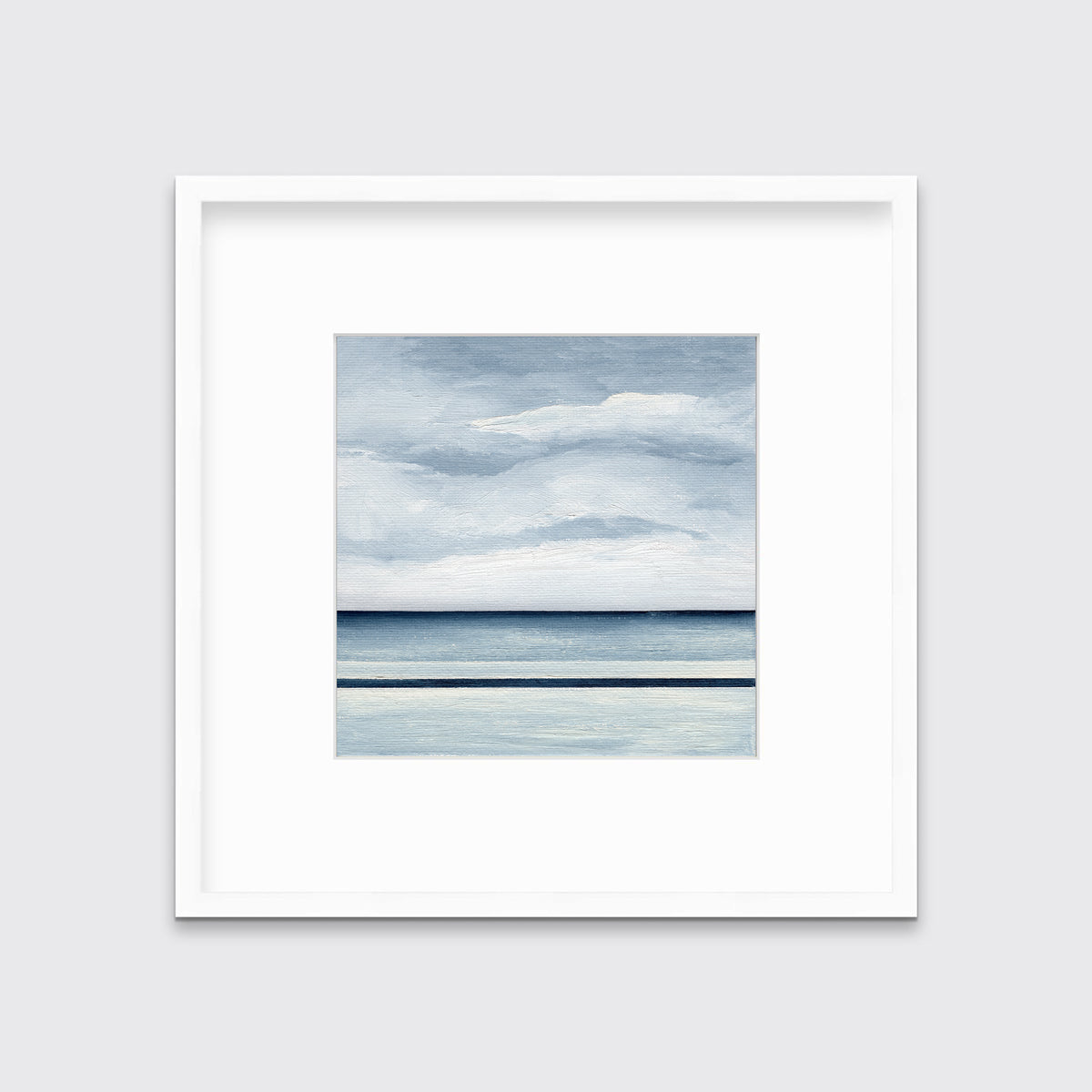 A blue and white abstract linear landscape print in a white frame with a mat hangs on a white wall.
