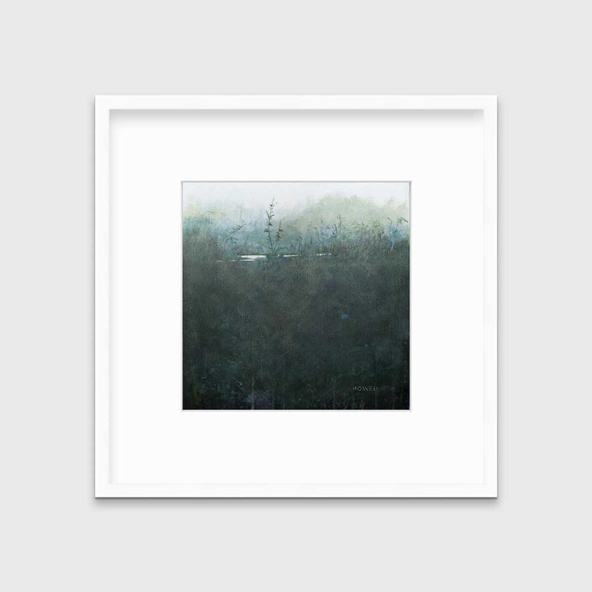 A dark muted teal abstract landscape print in a white frame with a mat hangs on a white wall.