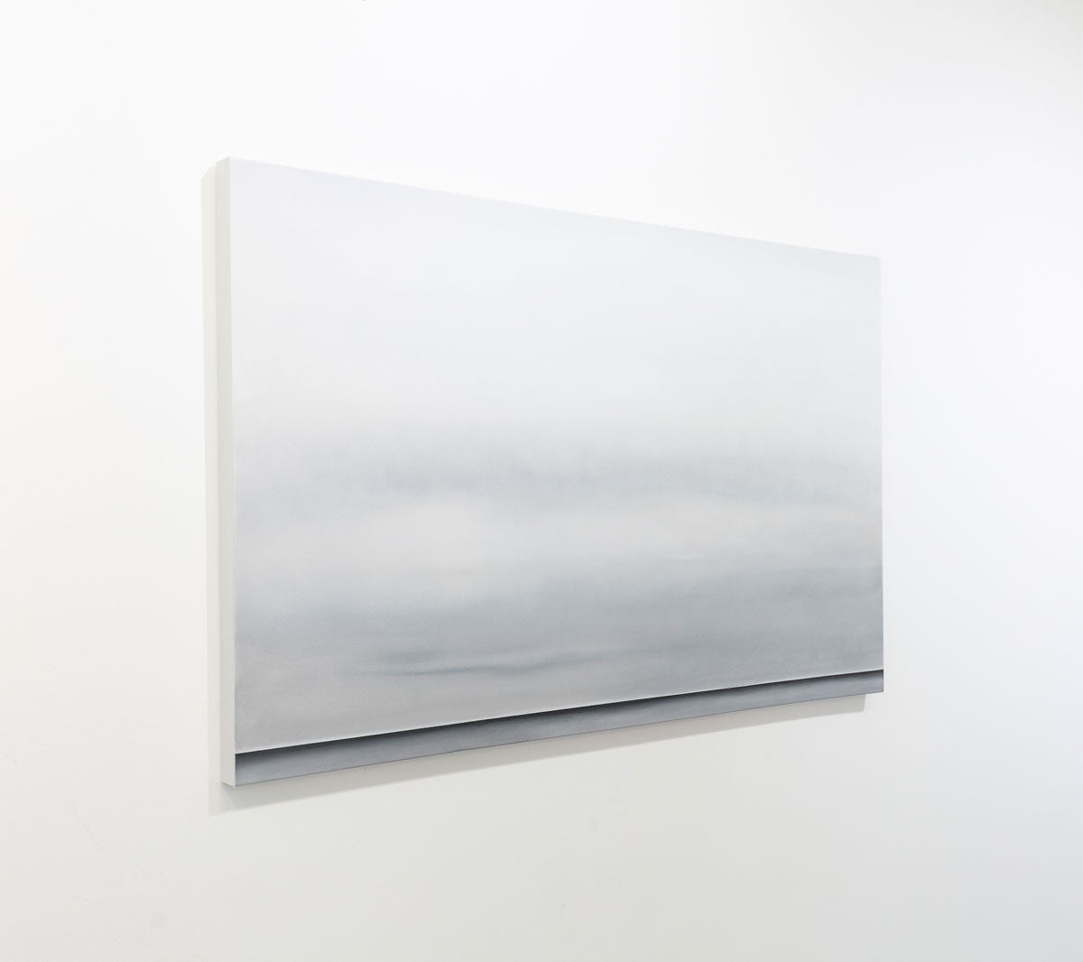 A grey oil painting with a single black line at the bottom that suggests a horizon line is seen at an angle on a gallery wall. Wired and ready to hang.