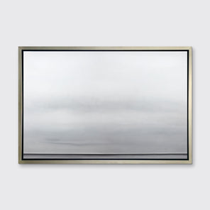 A tonal grey abstract landscape print in a silver floater frame hangs on a white wall.