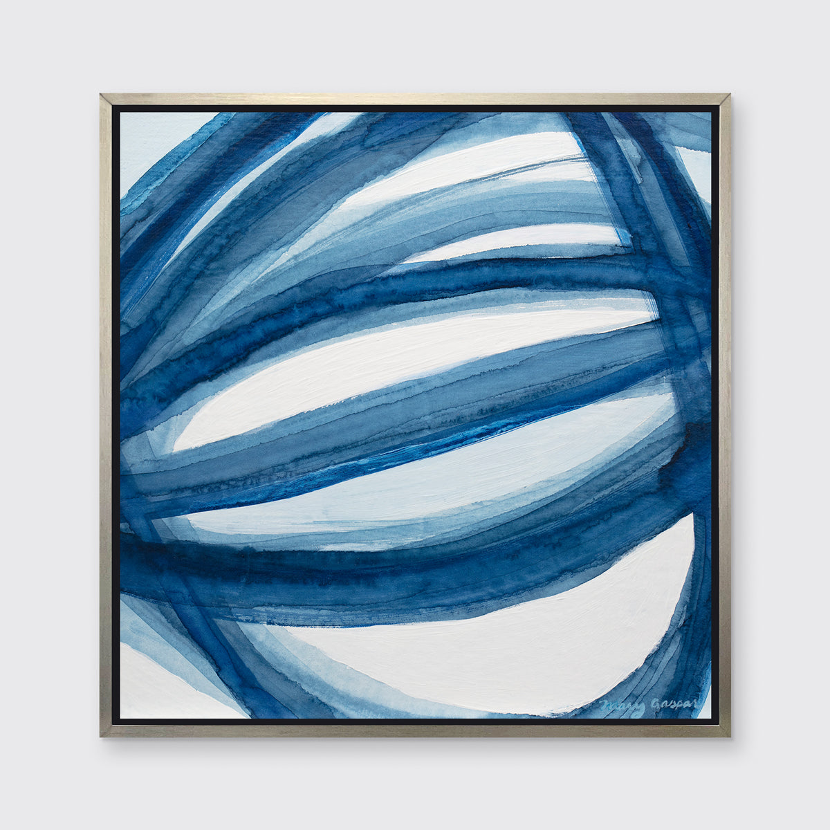 A blue and white abstract print in a silver floater frame hangs on a white wall.