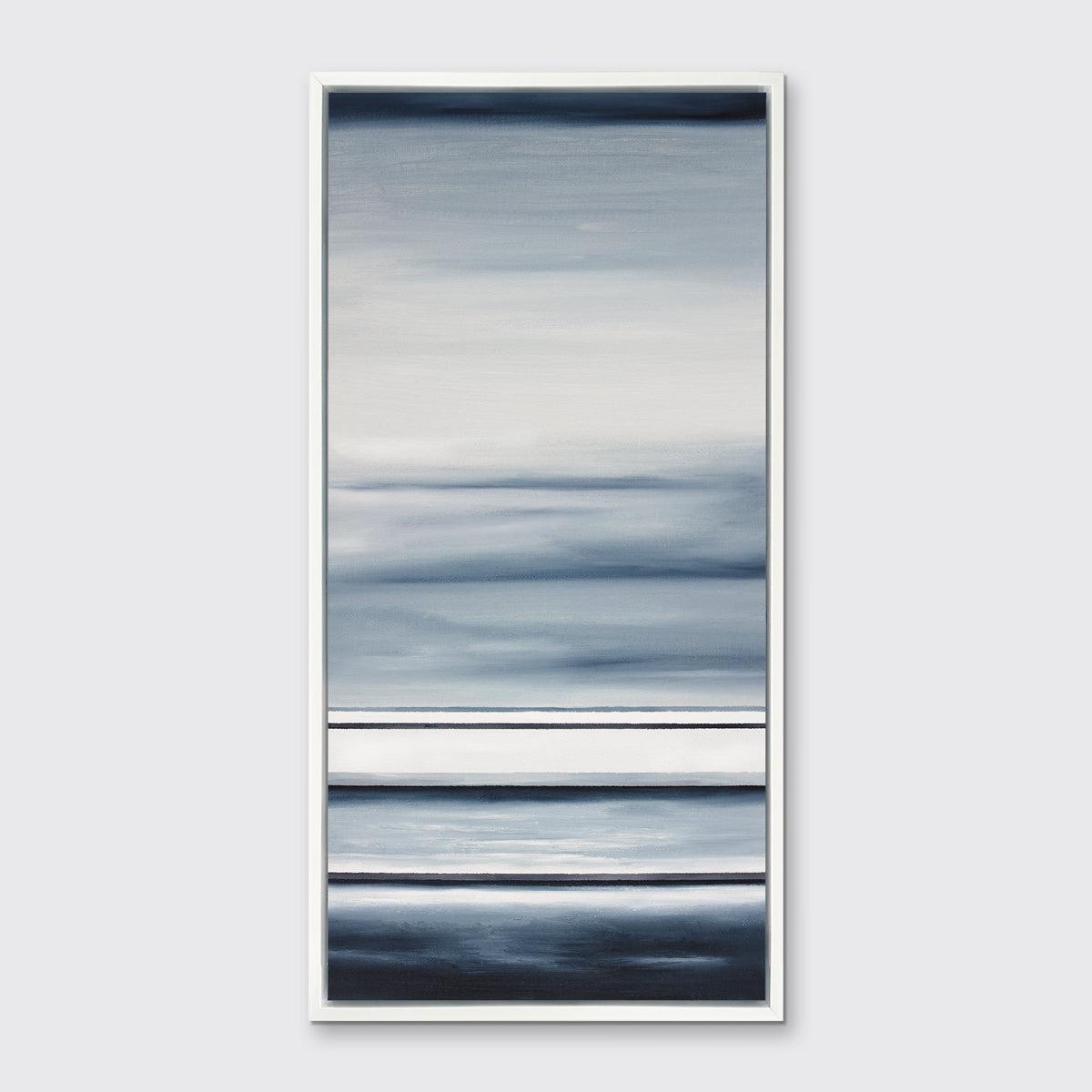 Different sized bands of hues of blue and white in a white floater frame on a wall.
