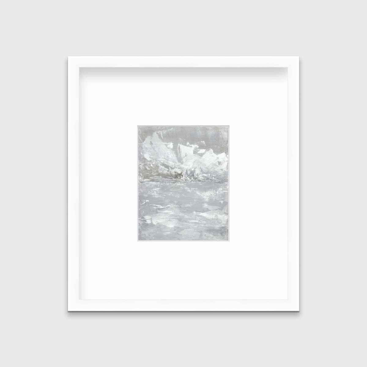 A white and grey abstract print in a white frame with a mat hangs on a white wall.