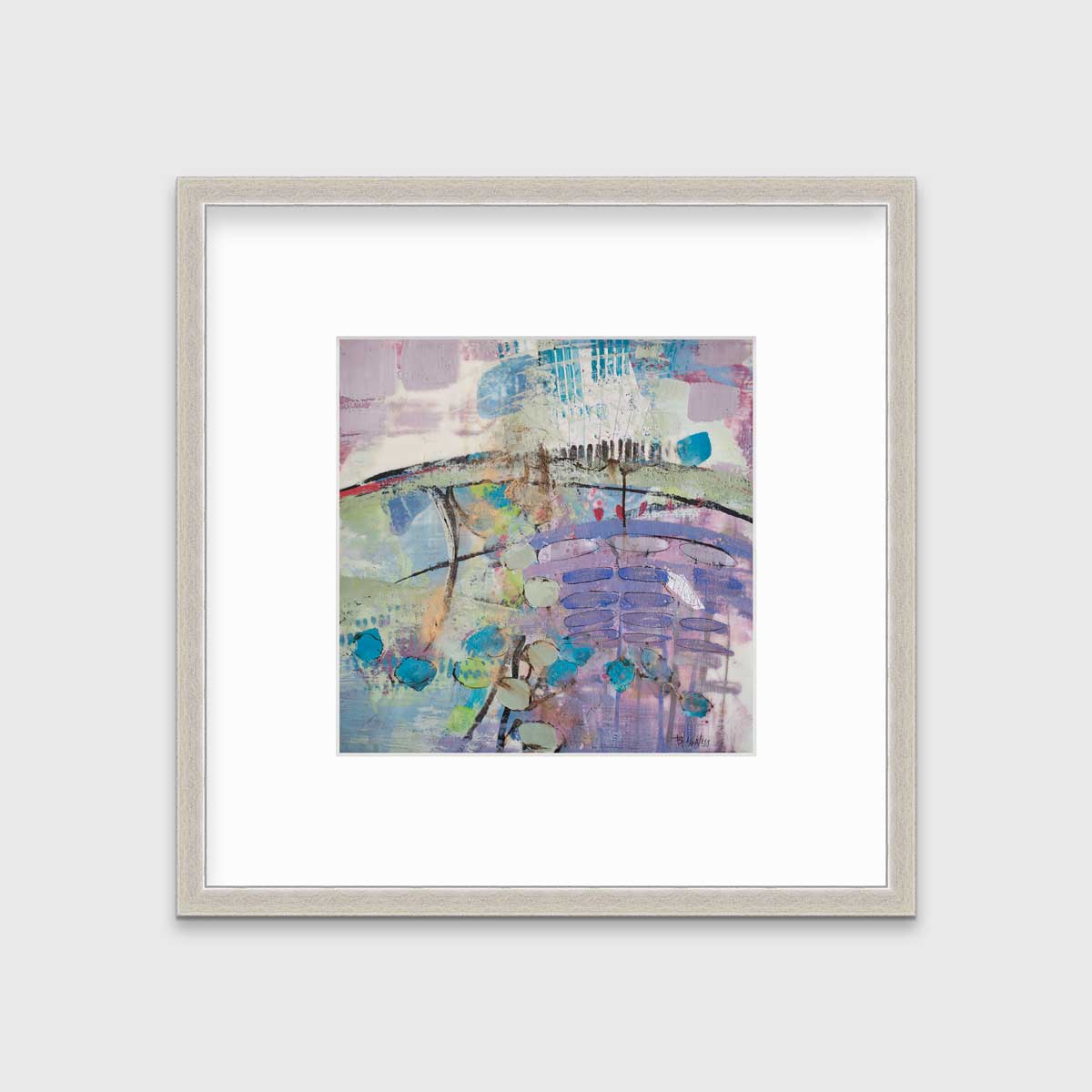 A purple, blue, green and teal abstract print in a silver frame with a mat hangs on a white wall.