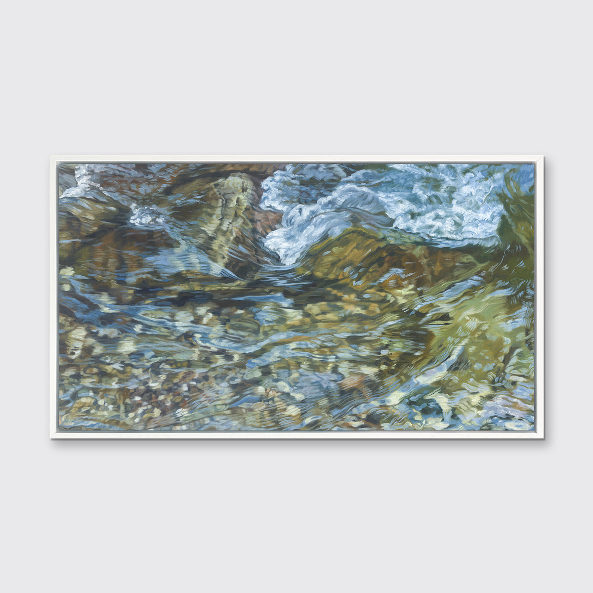 A green, blue, white and tan abstract river rock print in a white floater frame hangs on a white wall.